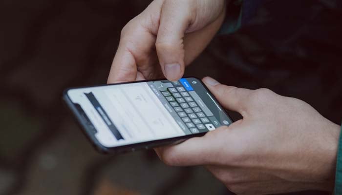 An undated image of a person typing on phone. — Unsplash