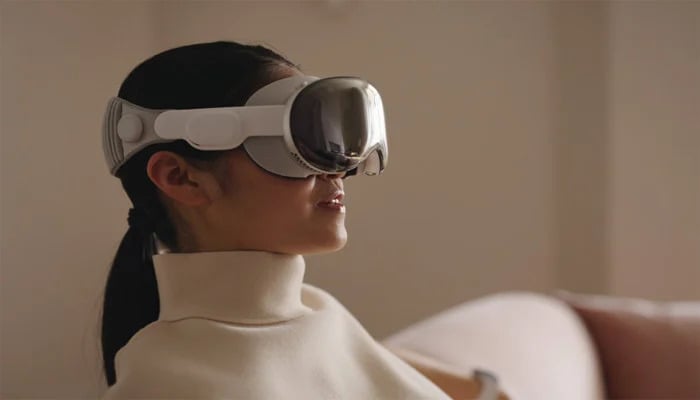 An undated image of a girl wearing a Vision Pro headset. — Apple