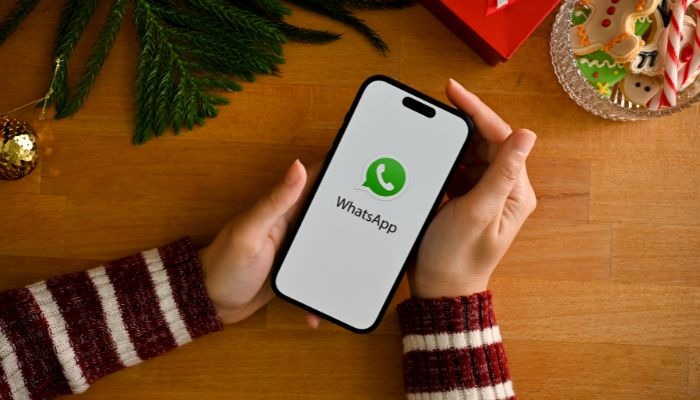 An undated image of a person using WhatsApp. —Canva