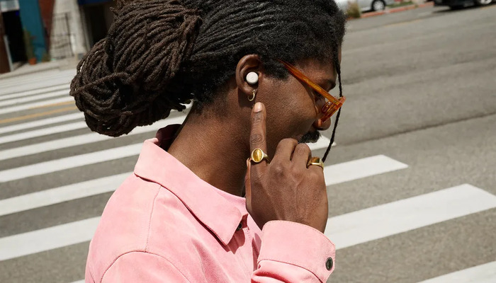 An undated image of a person using Google Pixel Buds. — Google Blog