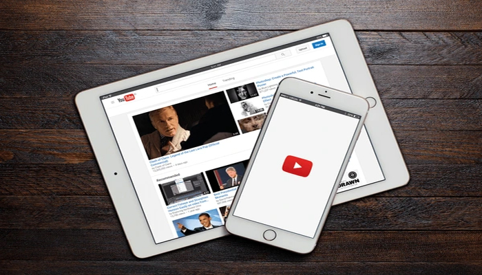 An undated image of YouTube displayed on smartphone, along with iPad. — ShutterStock