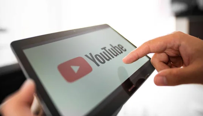 An undated image showing a person using YouTube app. — Depositphotos