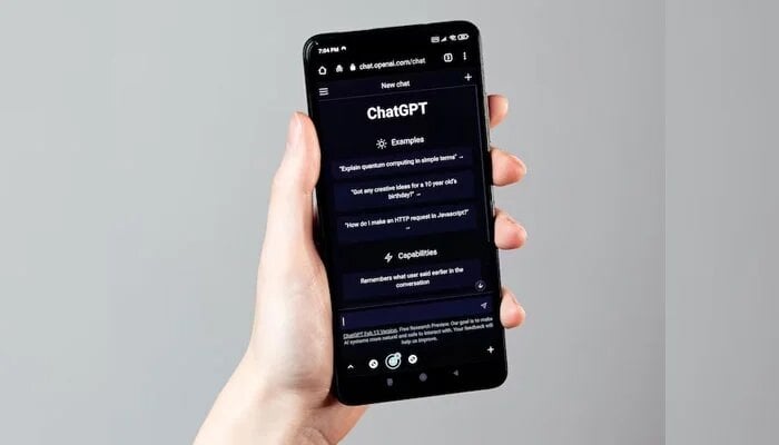 An undated image of a person using ChatGPT on phone. — Freepik