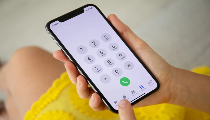 An undated image showing a girl using iPhone calling app. — Shutter Stock