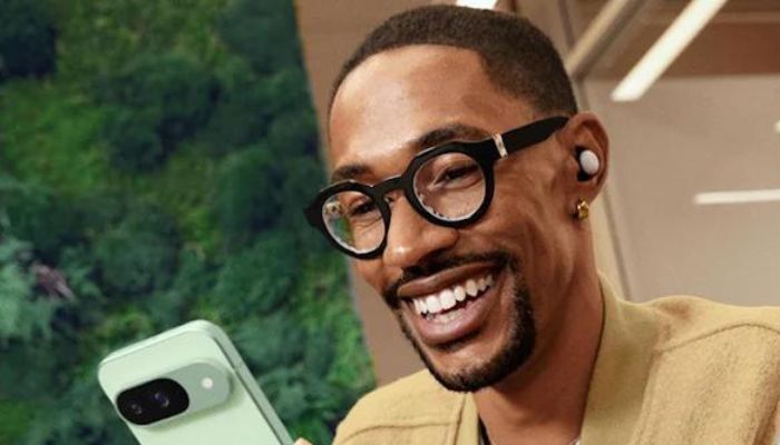 An undated image of a person using a Pixel 9 phone and Pixel Buds. — Google Store
