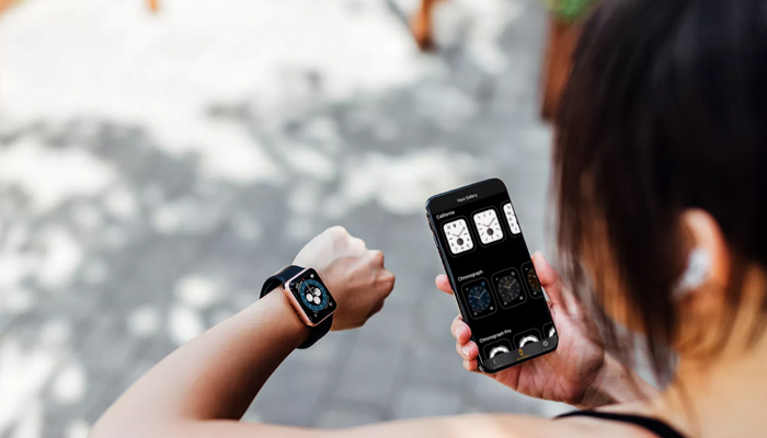 An undated image showing a girl interconnecting Apple Watch with iPhone. — Getty Images