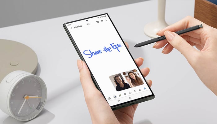 An undated image showing a person writing on Samsung device. — Samsung