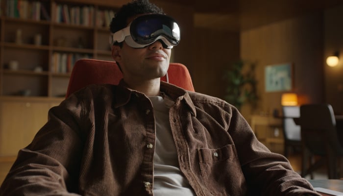 An undated image showing a person using Apple Vision Pro headset. — Apple