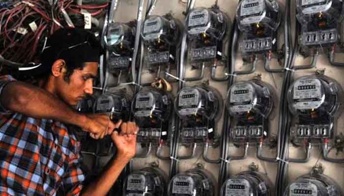 The picture shows a person working on the electricity meters in this undated photo. — AFP/File