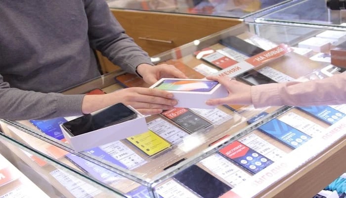 An undated image of a person buying a mobile phone. — Unsplash