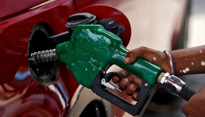An undated image showing a petrol pump worker fills the tank of a car. — Reuters