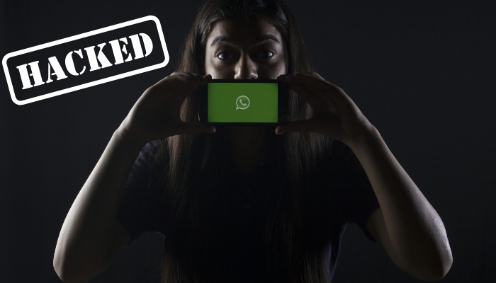 A representational image of WhatsApp being hacked. — Unsplash/Canva