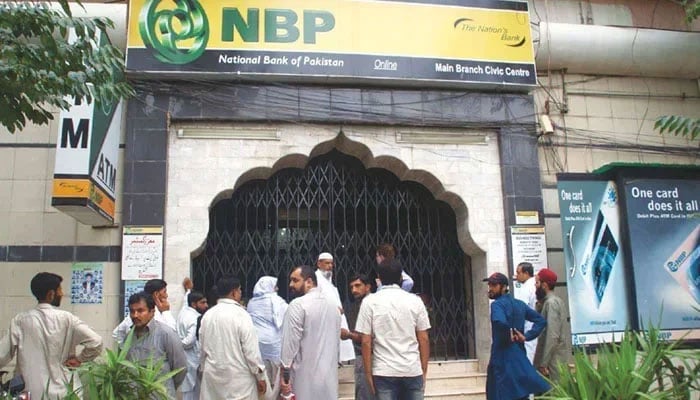 An undated image shows citizens lined up outside the National Bank of Pakistan. — APP