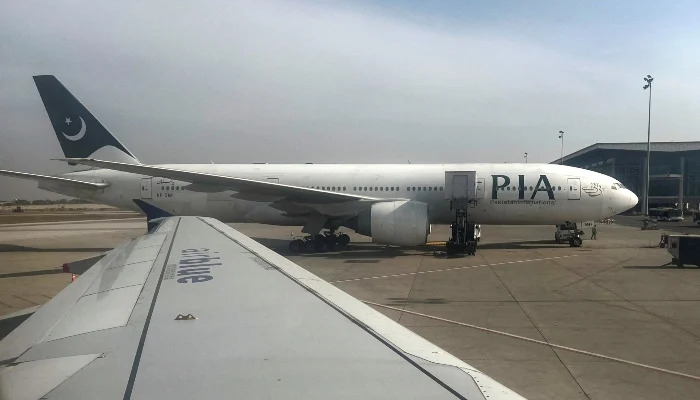 PIA passenger plane sits on tarmac , as seen through a plane window, at the Islamabad International Airport, Islamabad, on October 27, 2024. — Reuters
