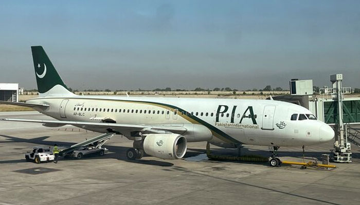 View of a Pakistan International Airlines (PIA) passenger plane, taken through a glass panel, at Islamabad International Airport, Pakistan October 3, 2023. — Reuters