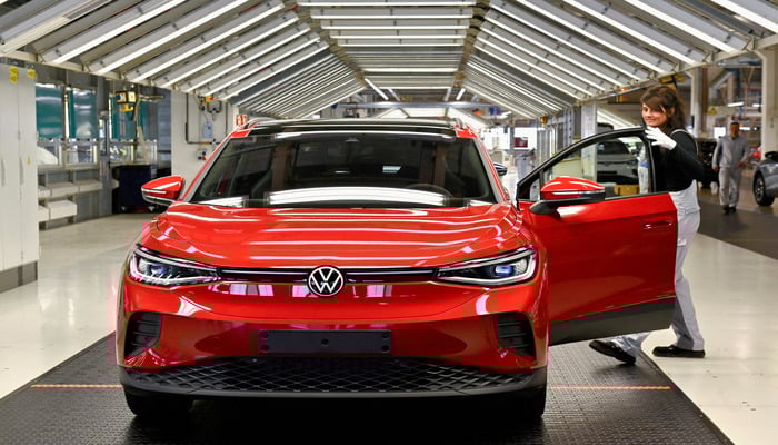 A technician inspecting an electric Volkswagen ID. 4 car model at the production plant of the Volkswagen Group in Zwickau, Germany, April 26, 2022. — Reuters