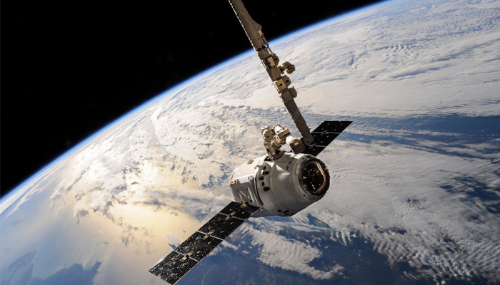 An undated image of a satellite over the Earths orbit. — Pexels