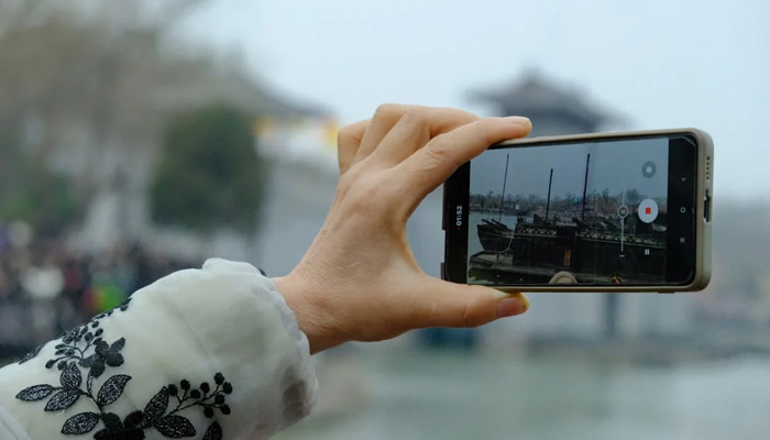 An undated image of a person taking a picture from Huawei. — Pexels