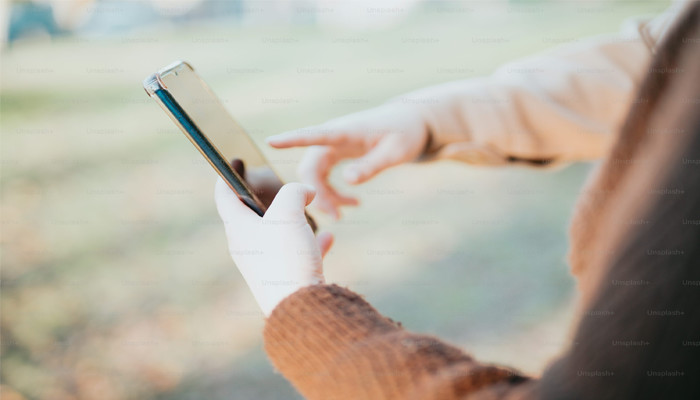 An undated iamge of a person using phone. — Unsplash