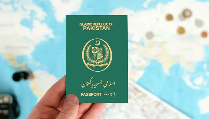 An undated image of a Pakistani passport in hands. — Shutterstock