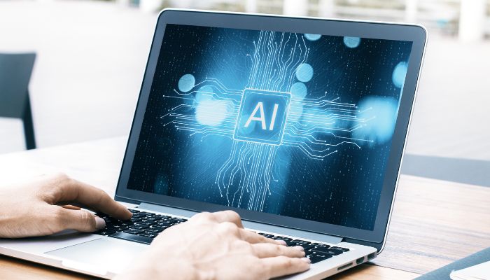 An undated image of AI logo displayed on a laptop screen. — Canva