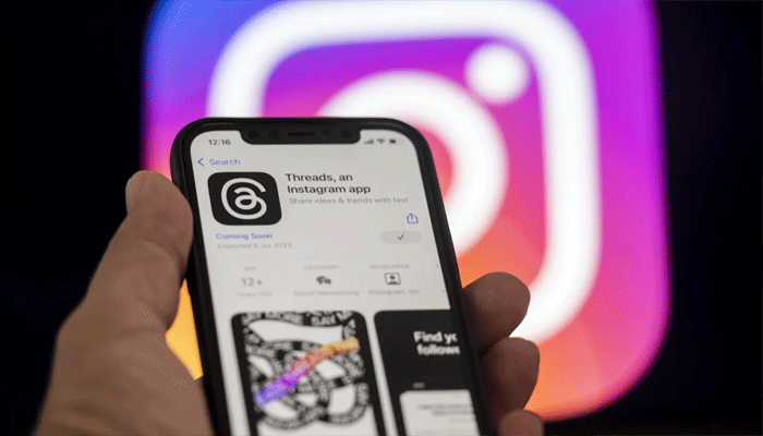 An undated image of Threads app on a smartphone, along with Instagram logo in background. — Getty Images