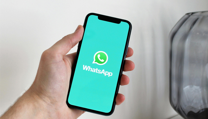 An undated image of WhatsApp logo displayed on a smartphone. — Pexels