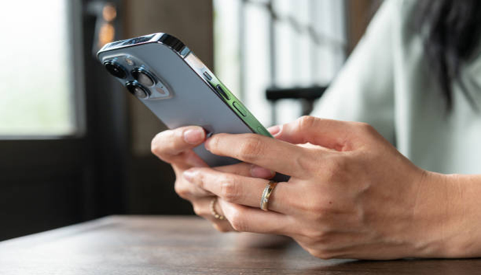 An undated image showing a person using iPhone. — iStock