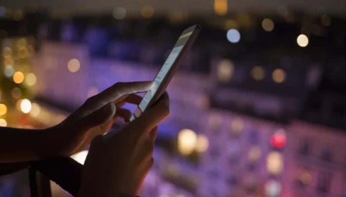 An undated image of a person using a smartphone.