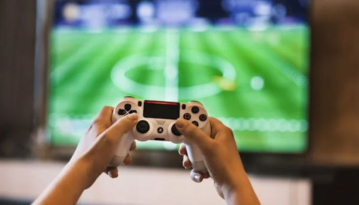 An undated image of a person playing on PlayStation. — Pexels
