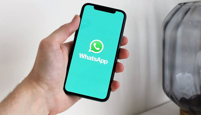 An undated image WhatsApp logo displayed on a smartphone. — Pexels