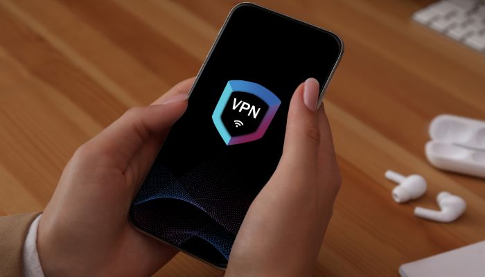 An undated image of VPN logo displayed on a smartphone. — Canva