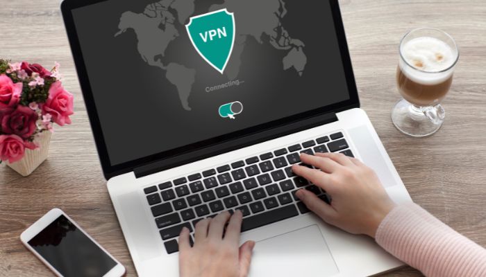 An undated image of a person using a VPN on a laptop. — Canva