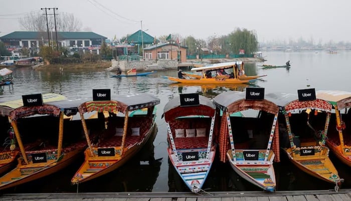 Uber signs are displayed on Shikaras or small boats after Uber launched its first water transport service on the waters of Dal Lake, one of Kashmirs main tourist attractions, in Srinagar, December 2, 2024. — Reuters