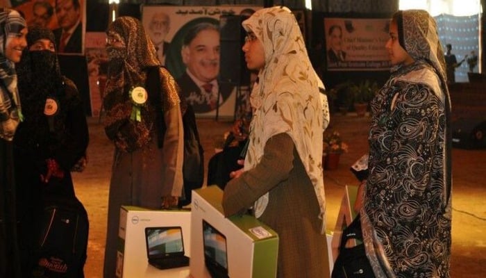 An undated image of students holding laptops. — Prime Minister Youth Programme