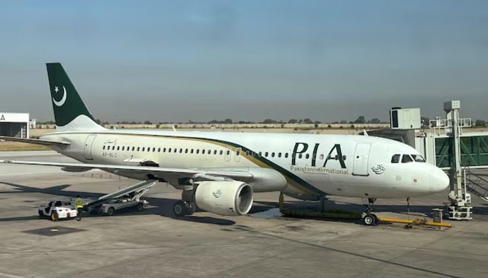 An image of PIA plane taken through a glass panel, at Islamabad International Airport, Pakistan October 3, 2023. — Reuters