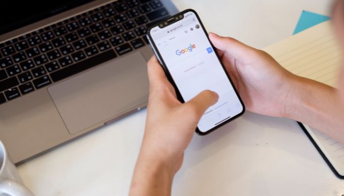 An undated image of a person using Google Search on a smartphone. — Canva