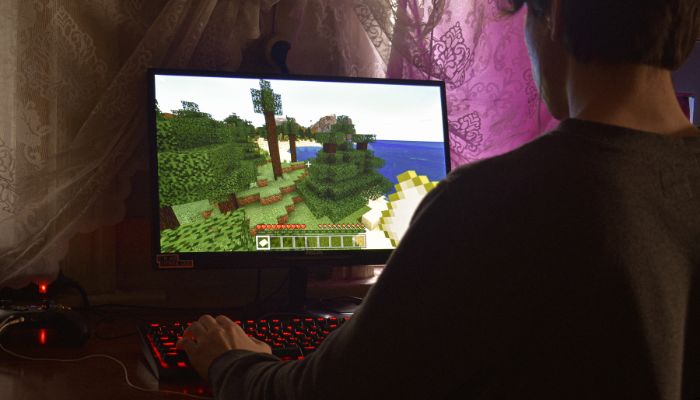 An undated image of a person playing a game on PC. — Canva
