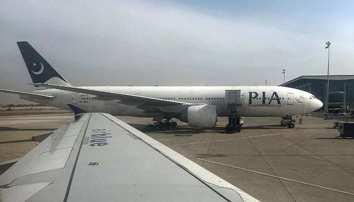 Pakistan International Airlines (PIA) passenger plane sits on tarmac, as seen through a plane window, at the Islamabad International Airport, Islamabad, Pakistan October 27, 2024. — Reuters