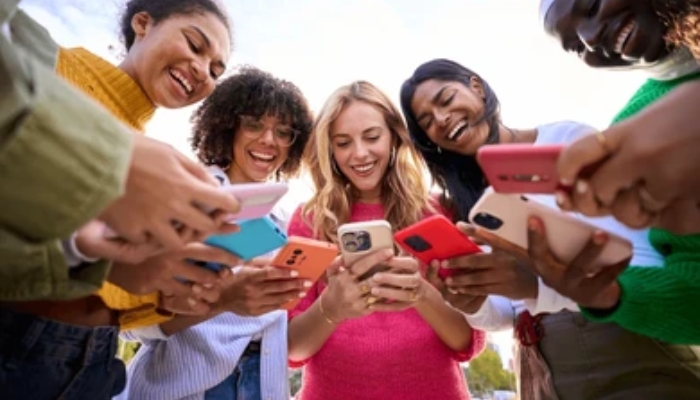 An undated image of group of people using their phones. — Shutterstock