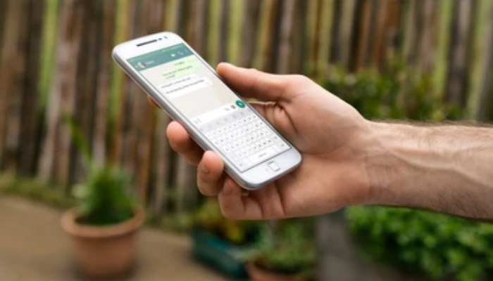 An undated image of a person using WhatsApp