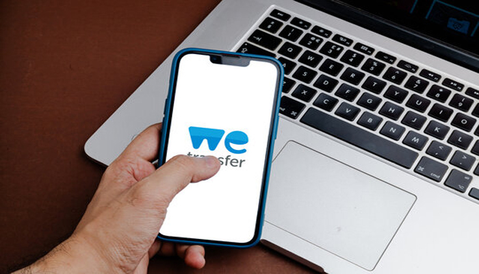 An undated image of WeTransfer displayed on a smartphone. — Adobe Stock