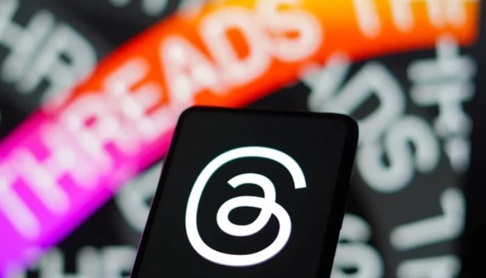 An undated image of Threads logo displayed on a phone. — Depositphotos