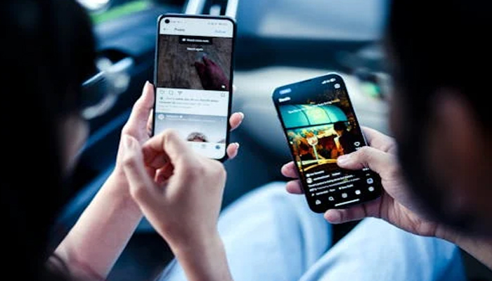 An undated image of two persons using Instagram. — Pexels