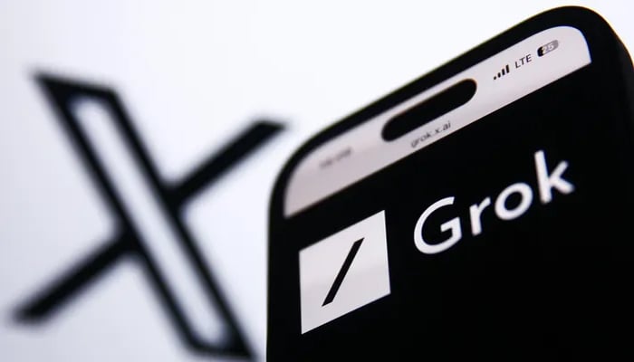 An undated image of Grok chatbot logo on a smartphone, along with X (formerly Twitter) logo at background. — Getty Images