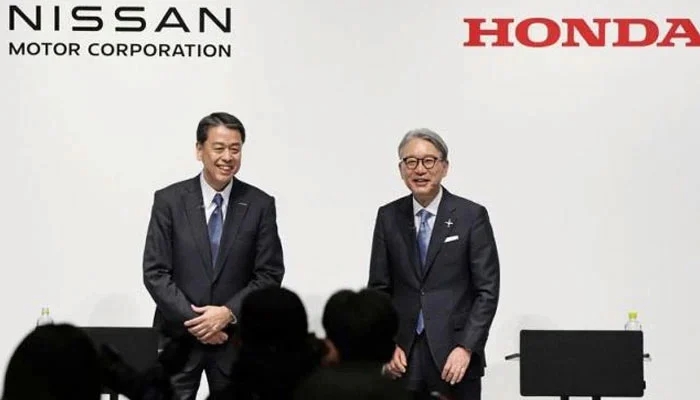 An image of Nissan Motor CEO Makoto Uchida and Honda Motor CEO Toshihiro Mibe attend press conference in Tokyo on Decemeber 23. — Reuters