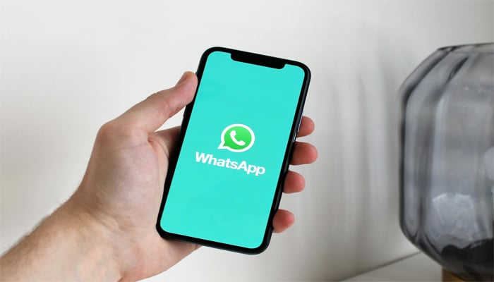 An undated image of WhatsApp logo displayed on a smartphone. — Pexels