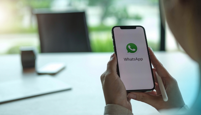 An undated image of the Whatsapp icon is displayed on a mobile screen. — Canva