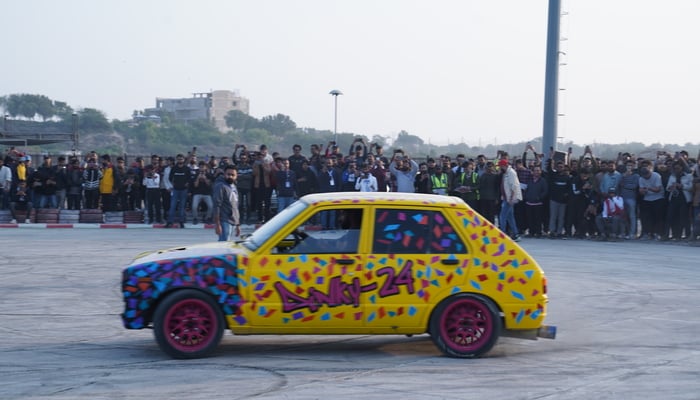 Crowd cheering in front of a drifting car at Pakwheels AutoShow in Karachi, on December 25, 2024. — Gadinsider via Syed Taha Nawaz