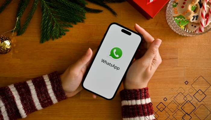 An undated image of WhatsApp logo displayed on a smartphone. — Canva